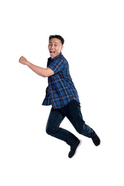 Beyaz arka planda izole edilmiş heyecanlı bir ifadeyle atlayan Asyalı Endonezyalı bir adamın portresi.