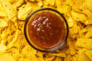 Cam kasede salsa soslu nachos tortilla cipsi yakından görülüyor. Yiyecek ve atıştırmalık konsepti