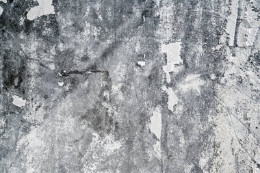 Yüksek desenli beyaz beton duvarın yakın görüntüsü. Yüzeyi eski ve soyulmuş boyayla yıpranmış. Soyut arkaplan