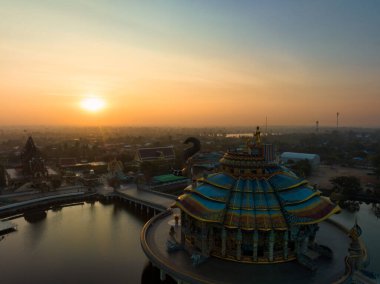 Nakhon Ratchasima, Thailand, Jan 15, 2023, Wat Ban Rai, Colorful complex with an elephant mosaic shrine in a lake, a tiled chapel headed naga statues.
