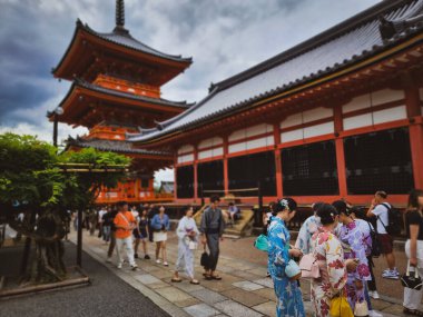 Kyoto 'daki Kiyomizu-dera Tapınağı' nda geleneksel kimono giyen turistler, tarihi mekanın keyfini çıkarıyorlar.