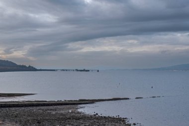 Looking up the River Clyde past the old Inverkip Power Station jetty on a quiet but cold day in winter with dramatic skys.