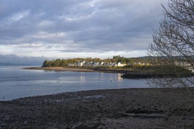 Looking over to the entrance of Kip Marina which fronts the village of Inverkip with the marina village and harbour view in the far distance.
