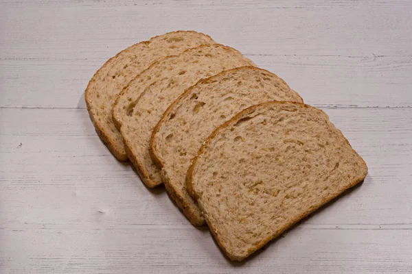 Four Slices Brown Oatmeal Bread Lying Wooden Board — Stock Photo, Image