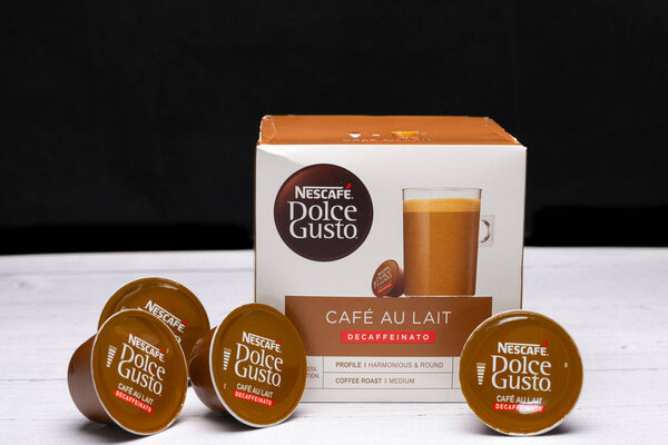 Irvine, Scotland, UK - March 26, 2024: Box of Nescafe Dolce Gusto Cafe AU Lait coffee capsules Drink obtained from dosed capsule with roasted, ground and compressed natural coffee box and pods are recyclable in the UK.