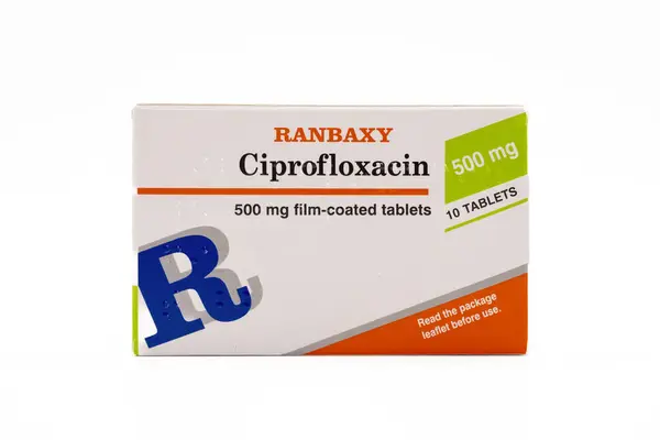 stock image Irvine, Scotland, UK - June 17, 2024: Ciprofloxacin 500mg antibiotic tablets by the Ranbaxy brand in a cardboard box and film dispenser displaying Braille, graphics icons and general information relevant to the image and product.