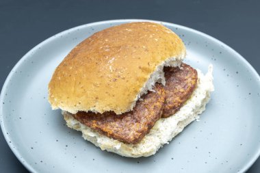 A traditional scottish oatmeal roll filled with two sliced sausages also known as Lorn Sausage. clipart