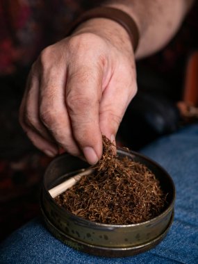 Kurutulmuş tütünle sarılmış sigara hazırlıyorum..