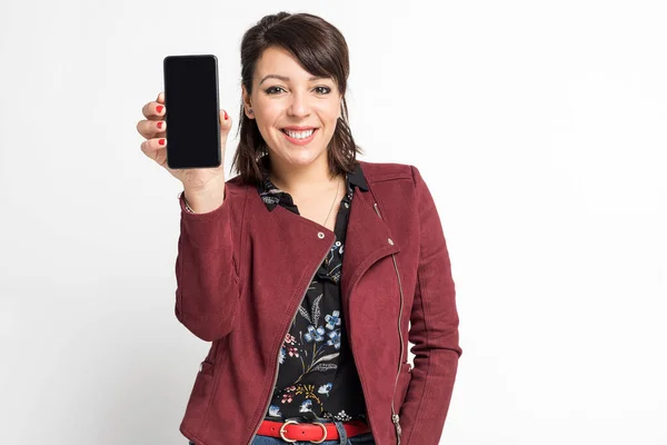 stock image happy latin young woman showing cellphone screen