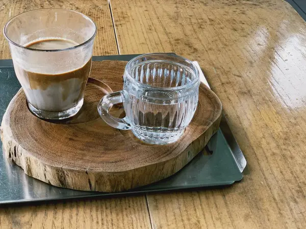 coffee cup on the corner of a brown wooden table with copy space. great for coffee drink ads