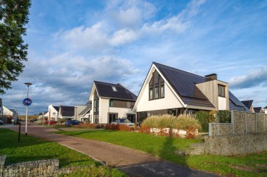 OLDENZAAL, NETHERLANDS - JANUARY 7, 2023: Modern new houses in a residential area on a beautiful winter day