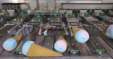 Ice cream on the conveyor line. Ice cream cone on the conveyor. Automated ice cream production line.