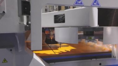 Cnc machine drills holes in the wooden shield. Cnc machine at technology exhibition.