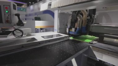 Cnc machine at the exhibition of hardware technology. CNC machine tool at work at the exhibition.