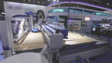 Cnc machine at the exhibition of hardware technology. CNC machine tool at work at the exhibition.