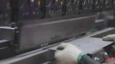 A man works for the machine. Asian man working on a hydraulic machine.