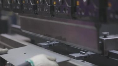 A man works for the machine. Asian man working on a hydraulic machine.