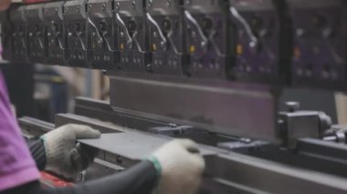 A man works for the machine. Asian man working on a hydraulic machine.