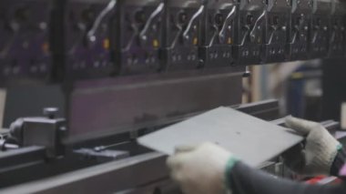 A man works for the machine. Asian man working on a hydraulic machine.