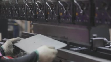A man works for the machine. Asian man working on a hydraulic machine.