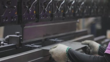 A man works for the machine. Asian man working on a hydraulic machine.
