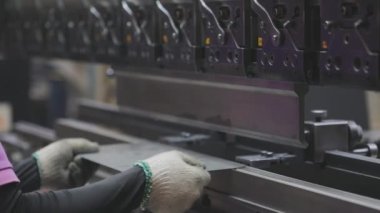 A man works for the machine. Asian man working on a hydraulic machine.