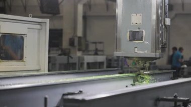 The process of drilling parts with liquid cooling on a large machine tool plant.