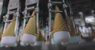 Ice cream on the conveyor line. Ice cream cone on the conveyor. Automated ice cream production line.