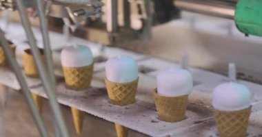 Ice cream on the conveyor line. Ice cream cone on the conveyor. Automated ice cream production line.