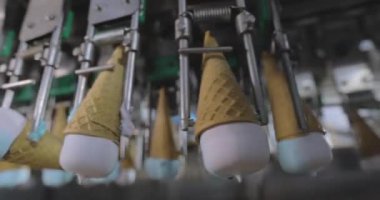 Ice cream on the conveyor line. Ice cream cone on the conveyor. Automated ice cream production line.