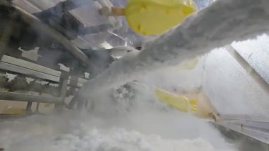 Ice cream is covered with bright glaze. Ice cream in yellow glaze. Colorful yellow ice cream on the conveyor.