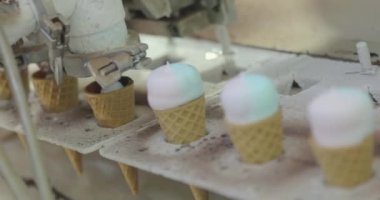 Ice cream on the conveyor line. Ice cream cone on the conveyor. Automated ice cream production line.