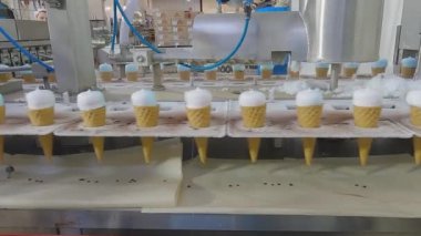 Ice cream on the conveyor line. Ice cream cone on the conveyor. Automated ice cream production line.