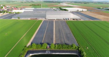 Flight around the reservoir for irrigation of agricultural fields. Reservoir with water on the agricultural field. Watering agricultural fields.