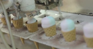 Ice cream on the conveyor line. Ice cream cone on the conveyor. Automated ice cream production line.