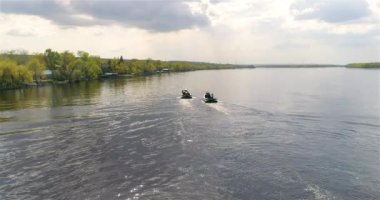 Devriye botları bir İHA 'dan görüldüğü gibi nehir boyunca ilerliyorlar. Nehirde yüksek hızlı devriye botu. Tekne çevrede devriye geziyor..