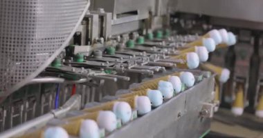 Ice cream on the conveyor line. Ice cream cone on the conveyor. Automated ice cream production line.