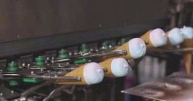 Ice cream on the conveyor line. Ice cream cone on the conveyor. Automated ice cream production line.