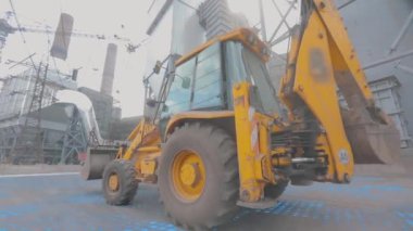 The backhoe works at the construction site. The concept of a smart backhoe. A smart construction site. Visualization of smart construction.