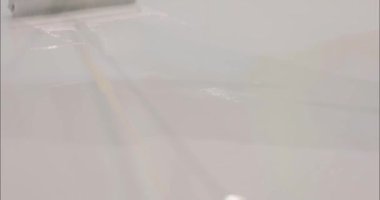 İnşaatçı, kazıyıcı şamandıra kullanarak reçine döşeme malzemelerini eşit olarak dağıtır. Bir müteahhit Tırmık Yüzgeci kullanarak polimer zemin uyguluyor. Polimer zemin oluşturma süreci.