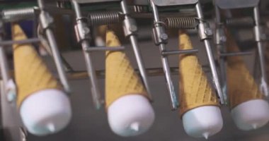Ice cream on the conveyor line. Ice cream cone on the conveyor. Automated ice cream production line.