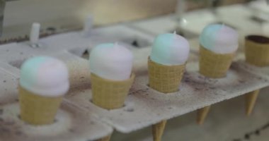 Ice cream on the conveyor line. Ice cream cone on the conveyor. Automated ice cream production line.