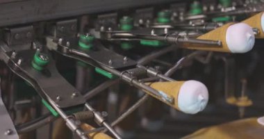 Ice cream on the conveyor line. Ice cream cone on the conveyor. Automated ice cream production line.