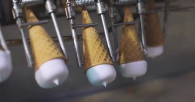 Ice cream on the conveyor line. Ice cream cone on the conveyor. Automated ice cream production line.