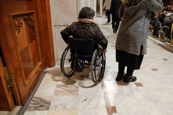 stock image Shallow depth of field (selective focus) details with a woman in a wheelchair during a convention.