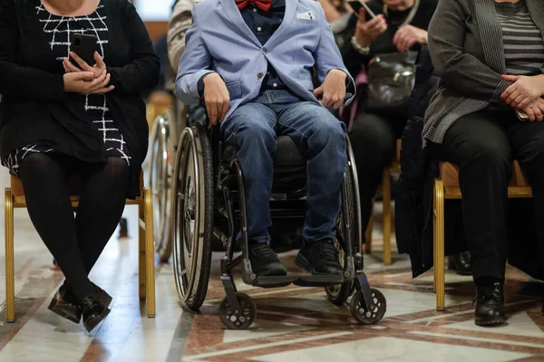 stock image Shallow depth of field (selective focus) details with a man in a wheelchair during a convention.