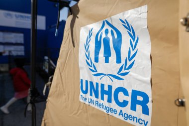 Bucharest, Romania - February 23, 2023: UNHCR, the UN Refugee Agency logo on a tent in a refugee camp. clipart