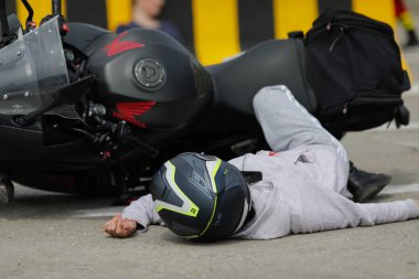 Otopeni, Romania - May 15, 2023: Motorcycle accident victim during a practice drill of the Romanian first responders, firefighters and paramedics. clipart