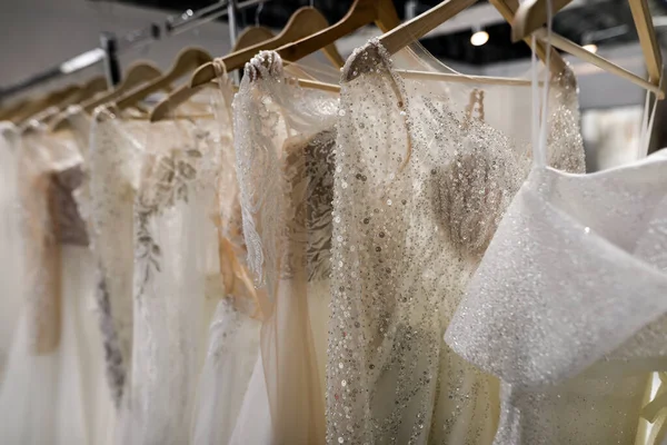 stock image Shallow depth of field (selective focus) details with wedding dresses on display in a shop.