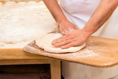 Esnaf ekmeği ve tatlı hazırlamak için diz çökerek. Usta hamur işi şefleri tarafından yapıldı.